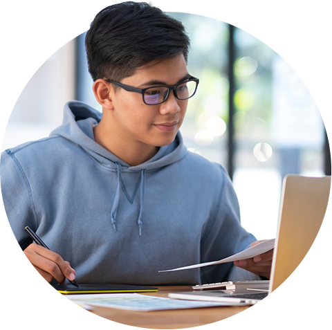 Male student with laptop and papers