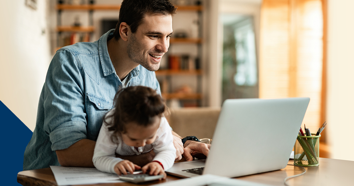 Man and baby working at laptop computer